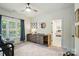 Bedroom boasts neutral colors, a ceiling fan, and an adjacent changing table at 7722 Garnkirk Dr, Huntersville, NC 28078