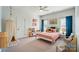 Bright bedroom with a ceiling fan, colorful bedding, and natural light at 7722 Garnkirk Dr, Huntersville, NC 28078