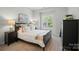 Comfortable bedroom with natural light, shutters, and neutral tones, creating a peaceful retreat at 7722 Garnkirk Dr, Huntersville, NC 28078