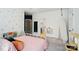 Bedroom boasts stylish wallpaper, neutral carpet and furnishings, and natural light at 7722 Garnkirk Dr, Huntersville, NC 28078