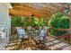 Outdoor dining area with a pergola, ceiling fan, and comfortable seating at 7722 Garnkirk Dr, Huntersville, NC 28078