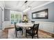 Elegant dining room with modern chandelier, wainscoting and seating for four at 7722 Garnkirk Dr, Huntersville, NC 28078