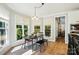 The dining room is filled with natural light, wood floors, and stylish seating at 7722 Garnkirk Dr, Huntersville, NC 28078