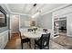Elegant dining room with modern chandelier, wainscoting and seating for four at 7722 Garnkirk Dr, Huntersville, NC 28078