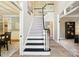 Grand foyer with staircase and open floor plan, showcasing elegant design and inviting atmosphere at 7722 Garnkirk Dr, Huntersville, NC 28078