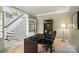 Spacious home office featuring a black desk, built-in bookcase, and a comfortable chair at 7722 Garnkirk Dr, Huntersville, NC 28078