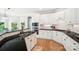 The kitchen has black countertops, stainless appliances, white cabinets, and a spacious design at 7722 Garnkirk Dr, Huntersville, NC 28078