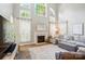Bright living room with a fireplace, large windows, and comfortable seating at 7722 Garnkirk Dr, Huntersville, NC 28078