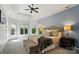 Luxurious main bedroom with tray ceiling, many windows, and neutral tones, offering ample space and comfort at 7722 Garnkirk Dr, Huntersville, NC 28078