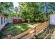 Spacious backyard featuring a storage shed, wooden fence, and ample greenery at 7733 Skyline Dr, Sherrills Ford, NC 28673