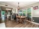 Charming dining area with a wooden table set by large windows, connecting to an open kitchen with stylish cabinetry at 7733 Skyline Dr, Sherrills Ford, NC 28673