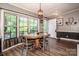 Inviting dining area with a round wood table, chairs, and a large window offering natural light at 7733 Skyline Dr, Sherrills Ford, NC 28673