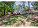 Inviting home featuring a charming covered porch and detached garage, nestled among mature trees on a spacious lot at 7733 Skyline Dr, Sherrills Ford, NC 28673
