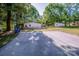 Property with a driveway leading to a home and storage shed, set amidst trees and nature at 7733 Skyline Dr, Sherrills Ford, NC 28673