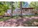 Charming home featuring a covered porch and spacious deck, surrounded by lush greenery at 7733 Skyline Dr, Sherrills Ford, NC 28673