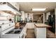 Open kitchen with white cabinets, butcher block countertops, tiled backsplash, and wood flooring at 7733 Skyline Dr, Sherrills Ford, NC 28673