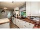 Fully equipped kitchen with white cabinets, butcher block countertops, tiled backsplash, and wood floors at 7733 Skyline Dr, Sherrills Ford, NC 28673