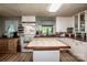 Spacious kitchen with white cabinets, butcher block countertops, a central island, and a window above the sink at 7733 Skyline Dr, Sherrills Ford, NC 28673