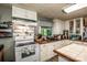 Charming kitchen with white cabinets, butcher block countertops, subway tile backsplash, and wood floors at 7733 Skyline Dr, Sherrills Ford, NC 28673