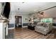 Spacious living room featuring wood-look floors, an open layout, fireplace, and comfortable seating at 7733 Skyline Dr, Sherrills Ford, NC 28673