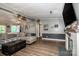 Cozy living room featuring a large sectional sofa, wood floors, brick fireplace, and lots of natural light at 7733 Skyline Dr, Sherrills Ford, NC 28673