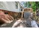 Back patio with wood stairs and railings in a secluded backyard setting at 7733 Skyline Dr, Sherrills Ford, NC 28673