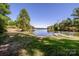 Picturesque waterfront lot featuring a grassy lawn leading to a peaceful lake with a private dock at 7733 Skyline Dr, Sherrills Ford, NC 28673