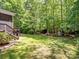 Lush backyard with a swing set, storage shed, and expansive lawn, ideal for outdoor activities at 8128 Sealey Ct, Charlotte, NC 28277