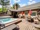 Backyard deck with hot tub, outdoor seating, and access to a screened porch, perfect for entertaining at 8128 Sealey Ct, Charlotte, NC 28277