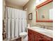 Bathroom with granite countertop, wooden cabinets and shower/tub combo at 8128 Sealey Ct, Charlotte, NC 28277