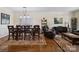 Elegant dining room featuring hardwood floors, crown molding, and a stylish chandelier at 8128 Sealey Ct, Charlotte, NC 28277