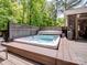 Relaxing hot tub on a wooden deck, surrounded by lush greenery, perfect for unwinding at 8128 Sealey Ct, Charlotte, NC 28277