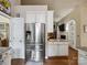 Stainless steel refrigerator and adjacent breakfast nook create a cozy and functional space at 8128 Sealey Ct, Charlotte, NC 28277