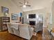 Inviting living room with vaulted ceiling, fireplace, and comfortable seating arrangement at 8128 Sealey Ct, Charlotte, NC 28277
