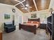 Spacious bedroom features vaulted wood-plank ceiling, large windows, and cozy seating area at 8128 Sealey Ct, Charlotte, NC 28277