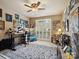 Office featuring a large window with custom shutters, artwork and ceiling fan at 8128 Sealey Ct, Charlotte, NC 28277
