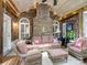 Inviting sunroom featuring brick wall, wooden ceiling, wicker furniture, and ample natural light at 8128 Sealey Ct, Charlotte, NC 28277