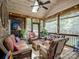 Cozy sunroom with wicker furniture, ceiling fan, skylight, and wood paneling, ideal for relaxation and entertaining at 8128 Sealey Ct, Charlotte, NC 28277