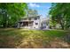Backyard with a tiered patio, grill, outdoor furniture, a screen porch and mature trees at 8501 Flanagan Ct, Huntersville, NC 28078