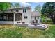 Backyard with a multi-tiered patio including an umbrella, fire pit and outdoor furniture at 8501 Flanagan Ct, Huntersville, NC 28078