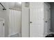 Well lit bathroom includes a shower with a curtain rod and a white door at 8501 Flanagan Ct, Huntersville, NC 28078