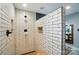 Walk-in shower in bathroom with white subway tile and rustic shower fixtures at 8501 Flanagan Ct, Huntersville, NC 28078