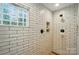 Shower featuring white subway tile with rustic shower fixtures and a glass block window at 8501 Flanagan Ct, Huntersville, NC 28078