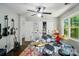 Attic conversion bedroom featuring guitars, a drum set, ceiling fan and bright lighting at 8501 Flanagan Ct, Huntersville, NC 28078