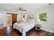Bright bedroom featuring wood floors and an ensuite bathroom with sliding barn door at 8501 Flanagan Ct, Huntersville, NC 28078