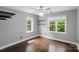 Bright bedroom with dual windows, ceiling fan, hardwood floors and shelves at 8501 Flanagan Ct, Huntersville, NC 28078
