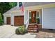 Inviting front entrance with a stained wood door and brick steps at 8501 Flanagan Ct, Huntersville, NC 28078