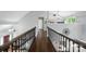 Second floor hallway with hardwood floors and views of the entry and main living area below at 8501 Flanagan Ct, Huntersville, NC 28078