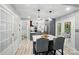 Open kitchen with island seating flows to the outdoor patio, perfect for dining and entertaining at 8501 Flanagan Ct, Huntersville, NC 28078