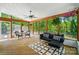 Enclosed back porch featuring wood flooring, a ceiling fan and plenty of sunlight at 8501 Flanagan Ct, Huntersville, NC 28078